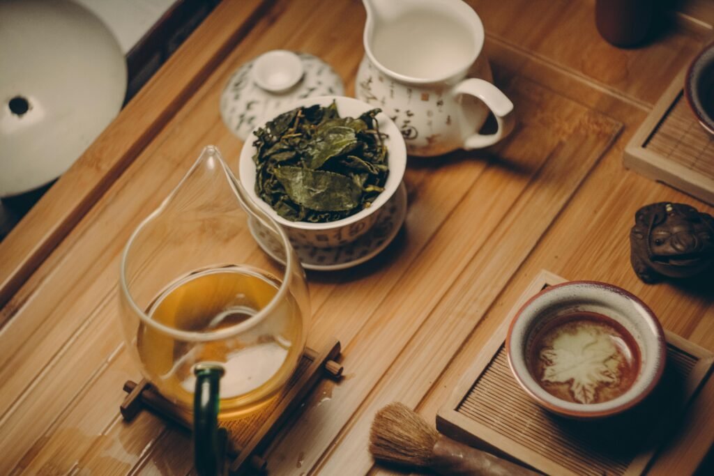 pexels-photo-229493-229493 Warm, inviting tea ceremony scene with traditional teapot, leaves, and cup on a wooden table.